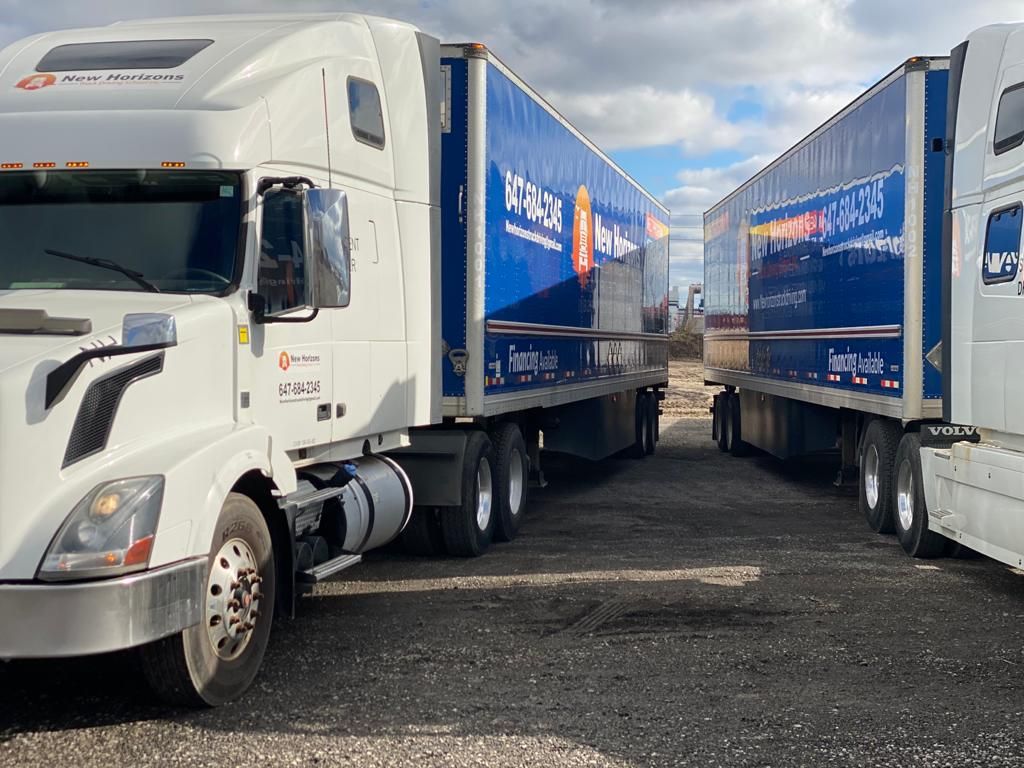Commercial trucks lined up at a fleet yard